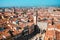 Sunny day in Verona, Italy. View from above on old town red roofs, square, streets and landmarks.
