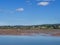 Sunny day view of the river Exe estuary at Exmouth, with unidentifiable boat grounded on sandbank. Devon, England. Low