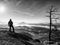 Sunny fall morning. Hiker is standing on the peak of rock in rock empires park