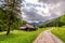 Sunny footpath in Tatras Mountains with wooden cottages, Poland