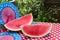 Sunny Fourth of July table with watermelon and red white and blue fans