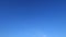 Sunny gradient blue sky background with minimal white clouds