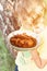 Sunny kid boy hands holding plate with cleaned and sliced chaga pieces. foraged chaga mushroom wild birch tree fungus it is used i