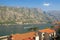 Sunny Mediterranean landscape. Montenegro, view of Bay of Kotor and red roofs of ancient town of Prcanj