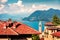 Sunny morning cityscape of Stresa town with Eglise de Vedasco church on background. Colorful summer view of Maggiore lake with