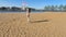 The on a sunny morning girl on a sandy beach does exercises with a gymnastic ribbon