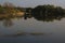 Sunny morning in the spring on the lake, reflection background