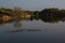 Sunny morning in the spring on the lake, reflection background