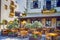 Sunny Open Air Cafe in Chania City on Crete. With Flowers and Olive Trees All Round in Crete, Greece