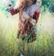 Sunny outdoor photo of a young woman enjoy spring in park