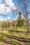 Sunny pasture with a dirt road in the spring