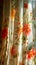 Sunny radiance illuminates the charming floral design on the curtain