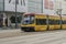 Sunny ride exploring warsaw on a modern yellow tram