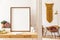 Sunny scanidnavian interiors of home apartment with mock up poster frame, wooden ladder, gold armchair, design accessories.