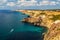 Sunny scenic blue sky landscape of rocky Black Sea coast and clear azure water viewed from Fiolent Cape in Sevastopol, Crimea,
