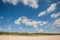 Sunny seaside scenery, fine white sand, blue sky and white clouds