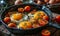 Sunny-side up eggs in a cast iron skillet with halved cherry tomatoes and chives, a rustic breakfast setup on a wooden table