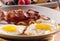 Sunny side up eggs with fried bacon.