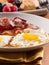 Sunny side up eggs with fried bacon.