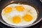 Sunny Side Up Eggs Frying in a Non-Stick Skillet