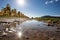 Sunny sky with reflection in puddle