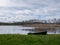 Sunny spring day landscape, bright blue sky with white clouds, boats on the shore of the lake