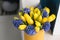 Sunny spring morning. Bunch of blue hyacinths and yellow tulips on white table. Present for a girl. Flowers bouquet in