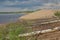 A sunny summer day on the beach, a wild village beach, sand, people, trees in the foreground