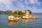 Sunny summer day. Picturesque lake with ruined fort on small island. View of National Park Lake Skadar. Montenegro