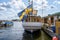 Sunny summer front stern view of the vintage classic steamship Motala Express with giant swedish flag in Stockholm.