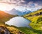 Sunny summer sunrise on Bachalpsee lake with Schreckhorn and Wet