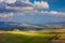Sunny Tuscany landscape - beautiful hills and sky with clouds