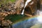 Sunny view of the Vernal Fall with a rainbow below