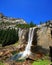 Sunny view of the Vernal Fall with a rainbow below