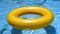 Sunny yellow pool float drifting in refreshing blue water of a serene swimming pool