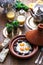 Sunnyside Eggs cooked in a Tajine dish with beef, Moroccan breakfast with juice and mint tea