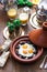 Sunnyside Eggs cooked in a Tajine dish with beef, Moroccan breakfast with juice and mint tea