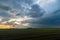 Sunrays at the back of a thunderstorm at sunset