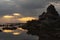 Sunrays break through the clouds over tufa silhouettes at Mono Lake during sunrise