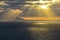 Sunrays piercing clouds over ocean