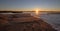 Sunrays and reeds at sunrise reflecting in the Santa Clara river / tidal inlet at McGrath State Park in Ventura California USA