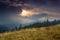 Sunrise above peaks of smoky mountain with the view of forest in the foreground.