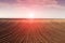 Sunrise above plowed field farmland