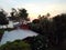 Sunrise Aerial Red House, trees, and beach in Waimanalo