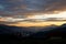 Sunrise in the austrian alps shining at mystic clouds up a sleeping valley in styria in the austrian alps