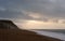 Sunrise on the beach, cloudy day. Chesil Beach in Dorset