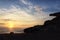 Sunrise on the beach and rock silhouettes