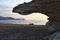 Sunrise on the beach and rock silhouettes