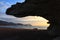 Sunrise on the beach and rock silhouettes