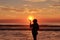 Sunrise at beach with silhouettes female woman